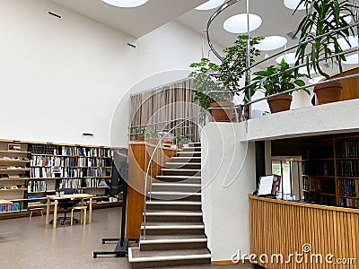 Reception and stairs in the library, shelves with books. Minimalistic interior. The library by Alvar Aalto Stock Photo