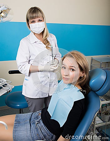 The reception was at the female dentist. Doctor examines the oral cavity on tooth decay. Caries protection. doctor puts Stock Photo