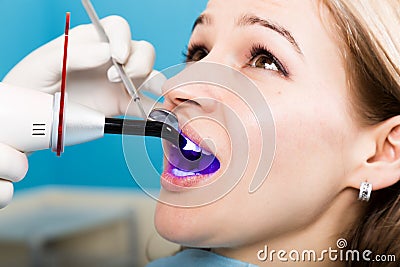 The reception was at the female dentist. Doctor examines the oral cavity on tooth decay. Caries protection. doctor puts Stock Photo