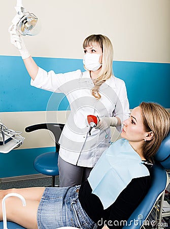 The reception was at the female dentist. Doctor examines the oral cavity on tooth decay. Caries protection. doctor puts Stock Photo