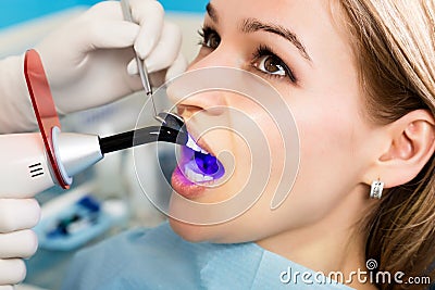 The reception was at the female dentist. Doctor examines the oral cavity on tooth decay. Caries protection. Tooth decay Stock Photo