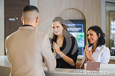 Receptionist hotel greeting thailand style for visitor check In Formal Stock Photo