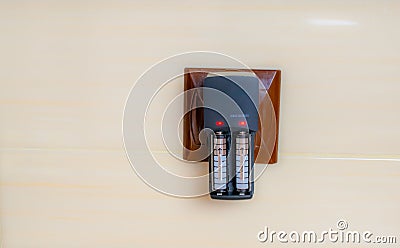 rechargeable batteries are charged in the mains charger Stock Photo