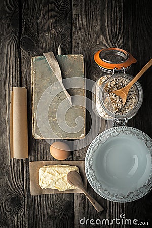 Recipe book, plate and ingredients for cookies on a wooden table Stock Photo