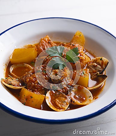 Cod loins cooked in the oven with tomato and clams. Stock Photo