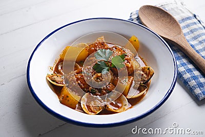 Cod loins cooked in the oven with tomato and clams. Stock Photo