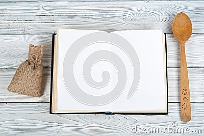 Recipe cook blank book on wooden background, spoon, rolling pin, checkered tablecloth Stock Photo
