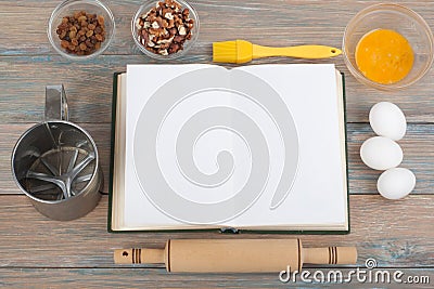 Recipe cook blank book on wooden background, spoon, rolling pin, checkered tablecloth Stock Photo