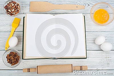 Recipe cook blank book on wooden background, spoon, rolling pin, checkered tablecloth. Top view Stock Photo
