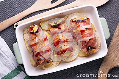 Spiced chicken rolled with bacon cooked in the oven. Stock Photo
