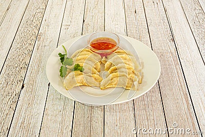 Recipe of traditional Chinese kuo tie dumplings cooked on the grill accompanied by sweet and sour sauce to dip Stock Photo