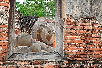 Reclining Buddha from window frame in Ayutthaya Stock Photo