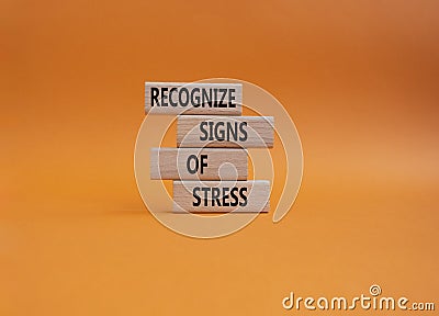 Recognize Signs of Stress symbol. Concept words Recognize Signs of Stress on wooden blocks. Beautiful orange background. Medicine Stock Photo