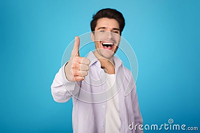 Recommend. Man showing thumb up and smiling Stock Photo