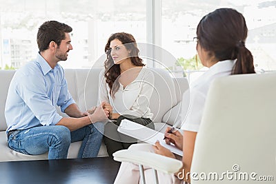 Reconciled couple smiling at each other Stock Photo