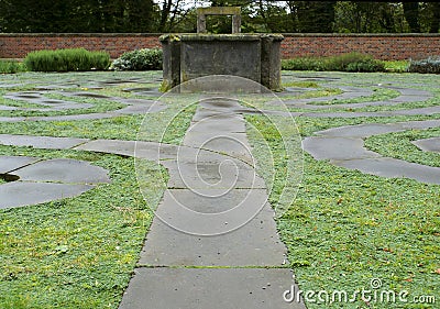 A metaphor for searching for our inner light: a well and a labyrinth Stock Photo