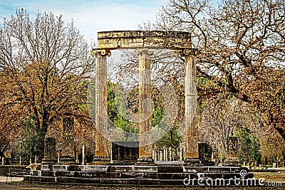 Reconstructed pillars of temple at ancient Olympia Greece on rounded foundation in wintertime Stock Photo