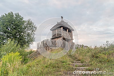 Reconstruction historical village wooden tower with palisade Stock Photo