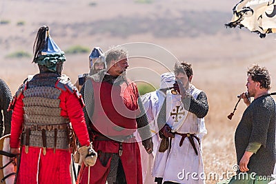 Reconstruction of Horns of Hattin battle in 1187. Captive knights of the Crusaders are drinking water from the cup, which he offer Editorial Stock Photo