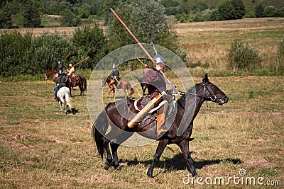 Reconstruction. Medieval armored knight with lance on horse from fantasy. Equestrian soldier in historical costume Stock Photo