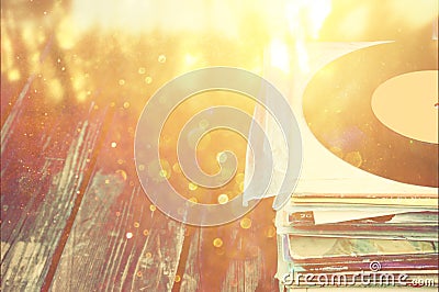 Records stack over wooden table and vintage light leaks filtered image Stock Photo