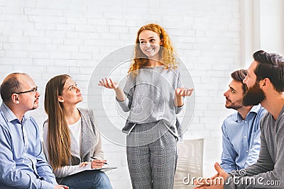 Young woman telling how she overcame drug addiction at group meeting Stock Photo