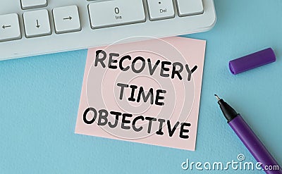 RECOVERY TIME OBJECTIVE - text in a notebook with a pen and keyboard Stock Photo