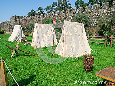 Recreated atmosphere of a medieval castle. Old architecture. Beautiful place. Tents on the lawn. Museum exhibits Editorial Stock Photo