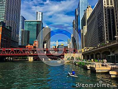 Recreation on the Chicago River, including kayaking, pedestrian walkway, fishing piers, surrounded by Editorial Stock Photo