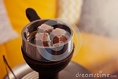 Hookah, coals and smoke in a relaxing environment Stock Photo