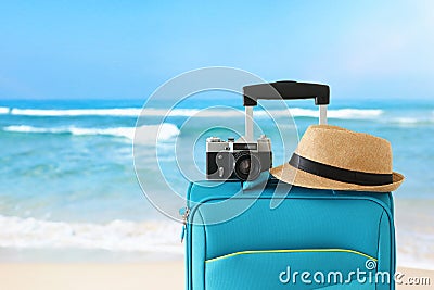 Recreation image of traveler luggage, camera and fedora hat infront of tropical background. holiday and vacation concept Stock Photo