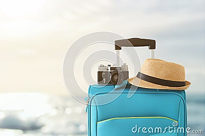 Recreation image of traveler luggage, camera and fedora hat infront of tropical sunset background. holiday and vacation concept Stock Photo