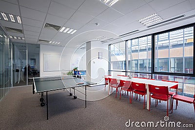 Office room with table, chairs and ping pong table Stock Photo