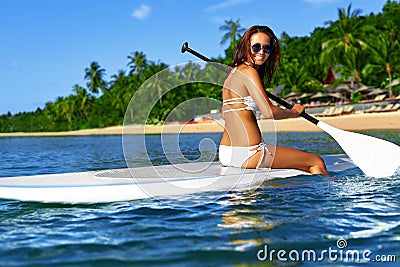 Recreational Sports. Woman Stand Up Paddle Boarding ( Surfing ). Stock Photo