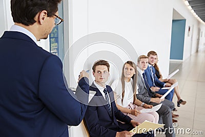 Recruiter addressing job candidates waiting for interviews Stock Photo