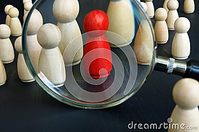 Recruitment Sourcing and strategies concept. Magnifying glass and figurine Stock Photo