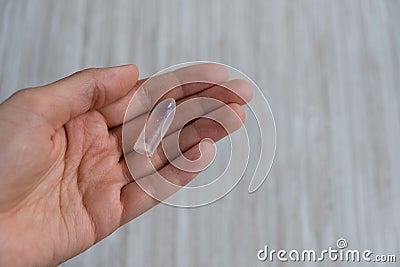 Rectal candle in hand on gray background Stock Photo