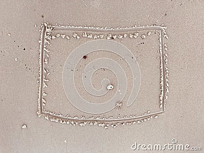 The rectangle shaped is written by hand in the sand Stock Photo