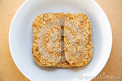 Rectangular wheat biscuits in a bowl Stock Photo