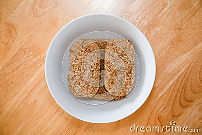 Rectangular wheat biscuits in a bowl Stock Photo