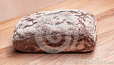 Rectangular wheat rye bread on a wooden board. Stock Photo