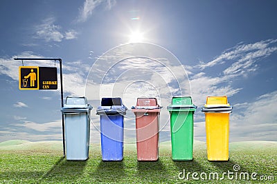 Recycle bins on green grass and sky background ,ecology concept. Stock Photo