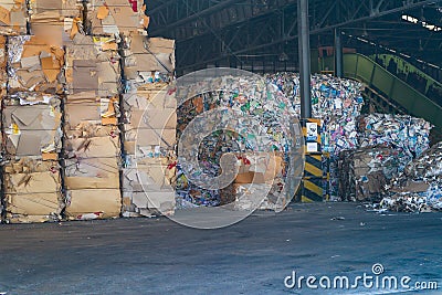 The recycle industry cardboard garbage and paper waste after pressing in hydraulic baling garbage press machine to a square dense Editorial Stock Photo