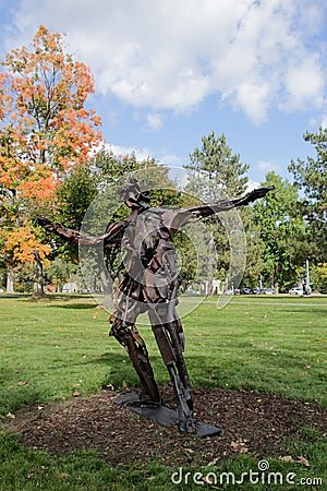 recycled metal art sculpture of a skater boy girl Editorial Stock Photo