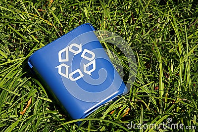 Recycling bin in bushes Stock Photo