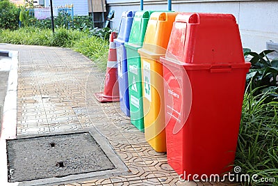 Recycling bins, yellow, red, green, blue for sorting in the dumping of garbage in Nakhon Sawan Province, Thailand, March 31, 2019 Stock Photo