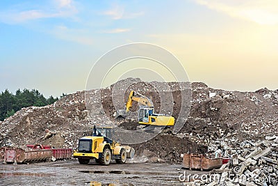 Recycling concrete and construction waste from demolition. Excavator and wheel loader at landfill of the disposa. Reuse of Editorial Stock Photo