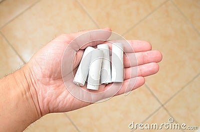 Recycling, energy, power, environment and ecology concept - close up of hand holding Ni-Mh rechargeable batteries heap Stock Photo