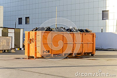 Recycling of garbage and waste, a large orange container for waste of a certain category a Stock Photo