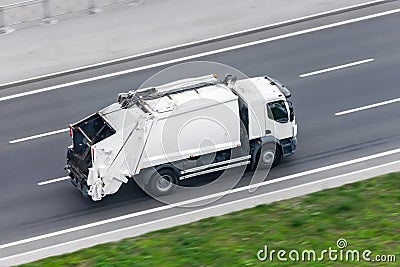 Recycling truck rides on the road in the city Stock Photo